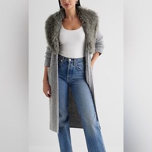 A chic duster cardigan featuring a removable faux fur collar, button front.